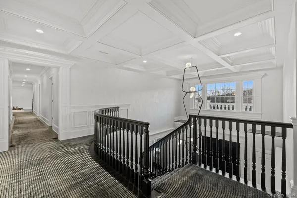a spacious bedroom with a bed and a flat screen tv