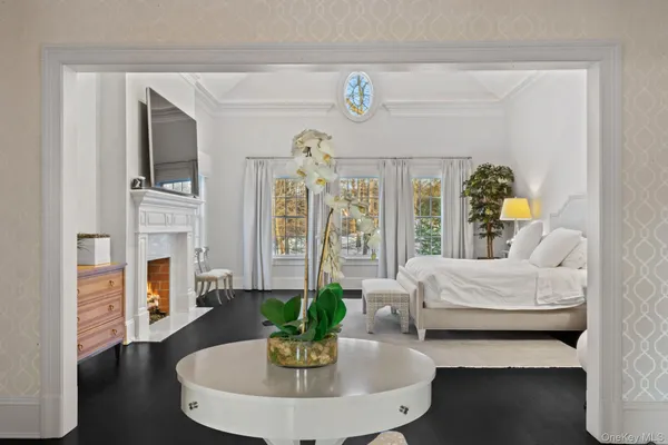 a living room with furniture flat screen tv and a large window