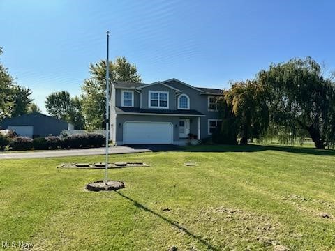 2761 Omega Road Greenwich, OH 44837 - Photo 2 of 50 Front facade featuring a front yard and a garage