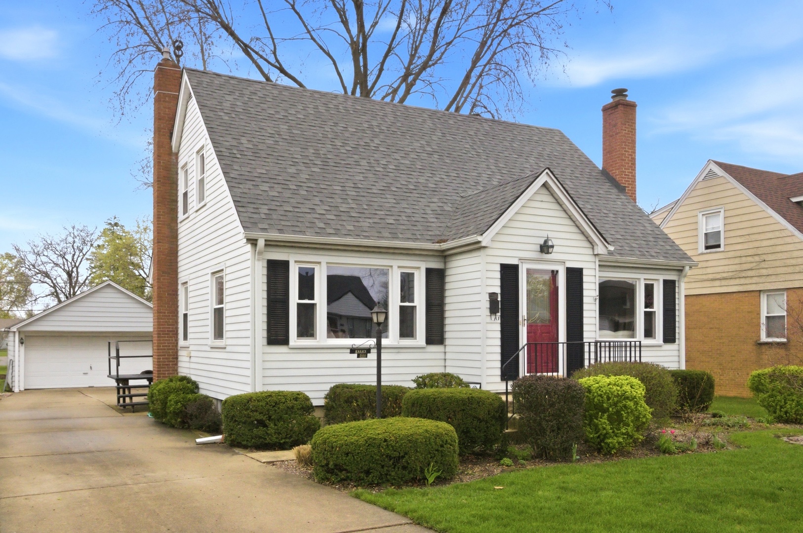 221 South Michigan Avenue Addison, IL 60101 - Photo 2 of 25 a view of a white house with a small yard and plants