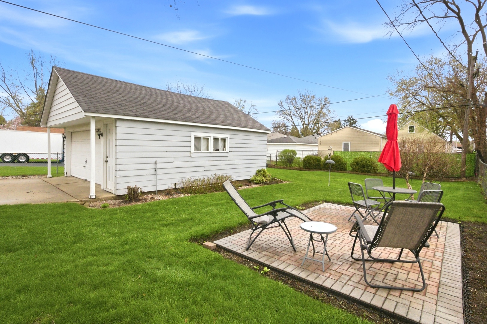221 South Michigan Avenue Addison, IL 60101 - Photo 25 of 25 a view of a chair and table in backyard of the house