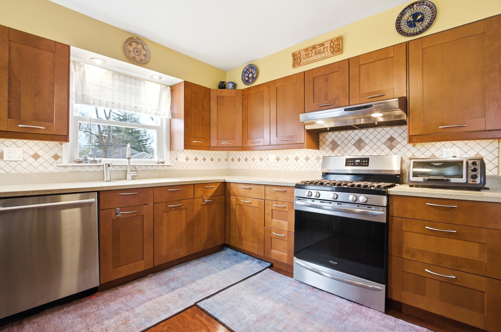 221 South Michigan Avenue Addison, IL 60101 - Photo 9 of 25 a kitchen with a stove a sink and a window