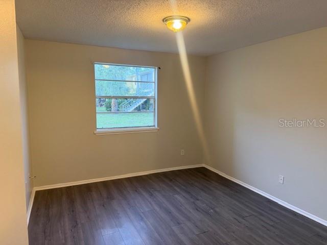7309 Abonado Road, Unit 7309 Tampa, FL 33615 - Photo 13 of 17 an empty room with wooden floor and windows