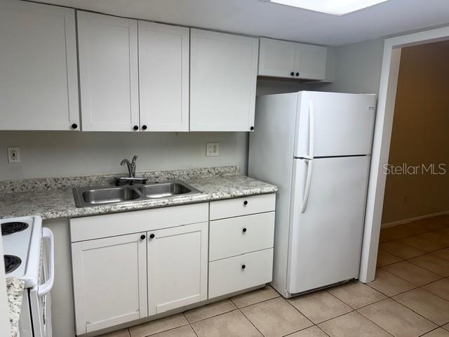 7309 Abonado Road, Unit 7309 Tampa, FL 33615 - Photo 2 of 17 a white refrigerator freezer sitting inside of a kitchen
