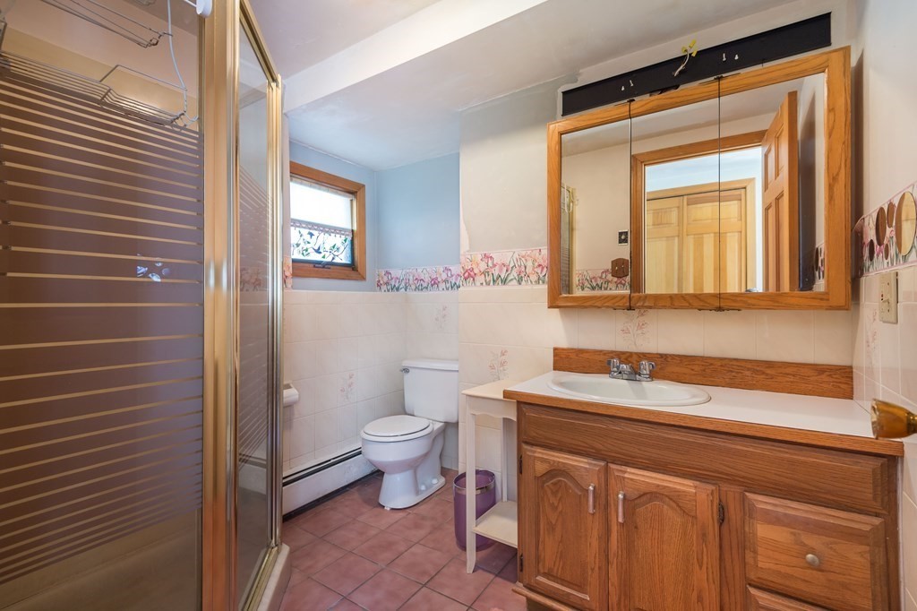 5 Rich Road Woburn, MA 01801 - Photo 19 of 25 a bathroom with a sink a toilet and mirror