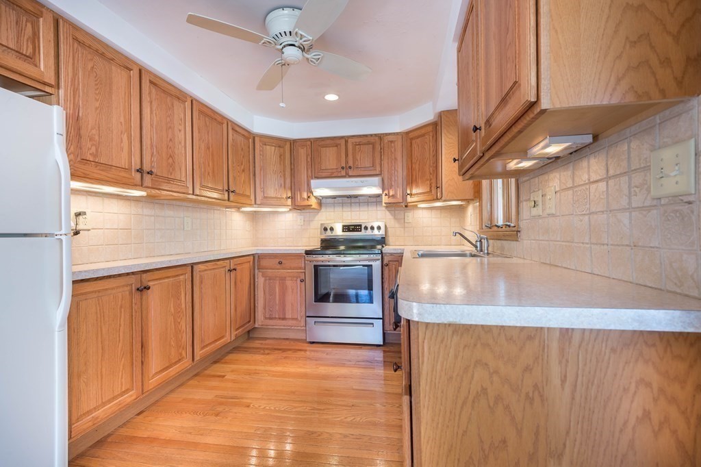 5 Rich Road Woburn, MA 01801 - Photo 4 of 25 a kitchen with granite countertop a sink stainless steel appliances and cabinets