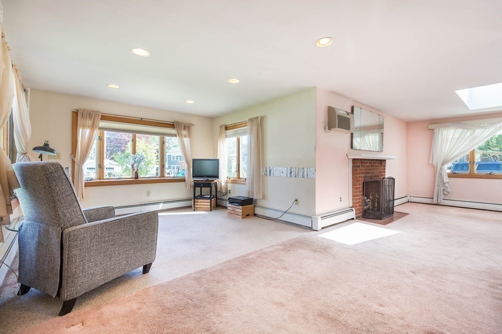 5 Rich Road Woburn, MA 01801 - Photo 7 of 25 a view of a livingroom with furniture and a flat screen tv