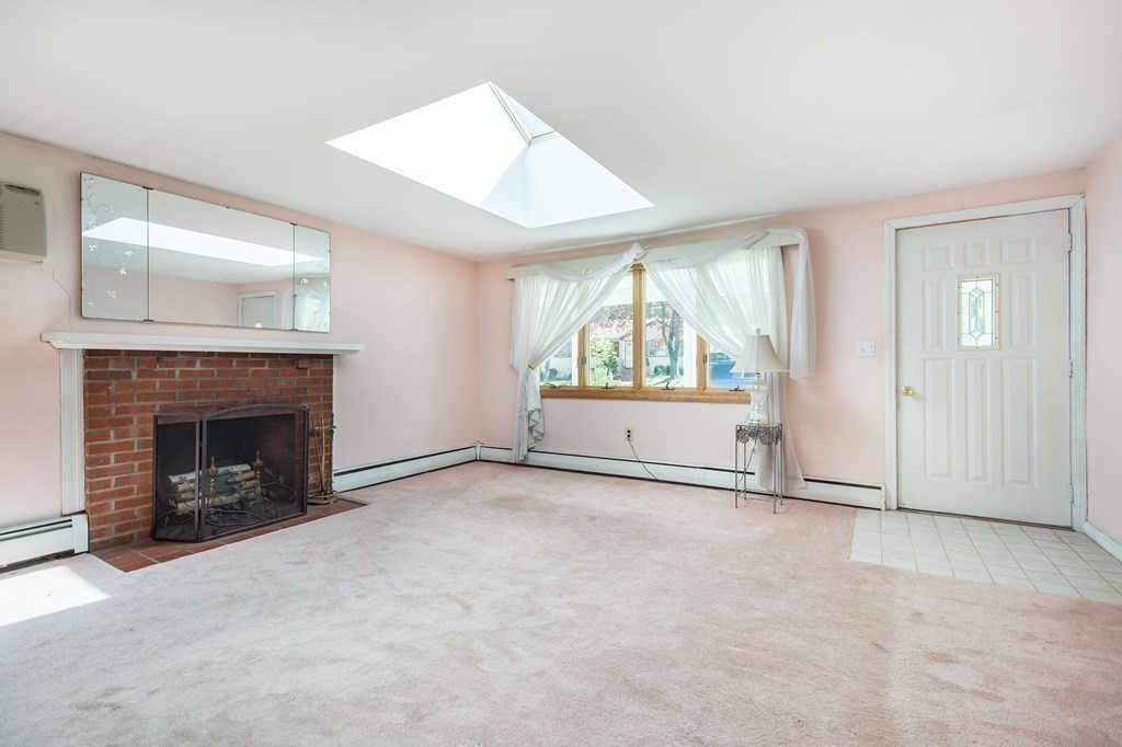 5 Rich Road Woburn, MA 01801 - Photo 8 of 25 an empty room with windows and fireplace