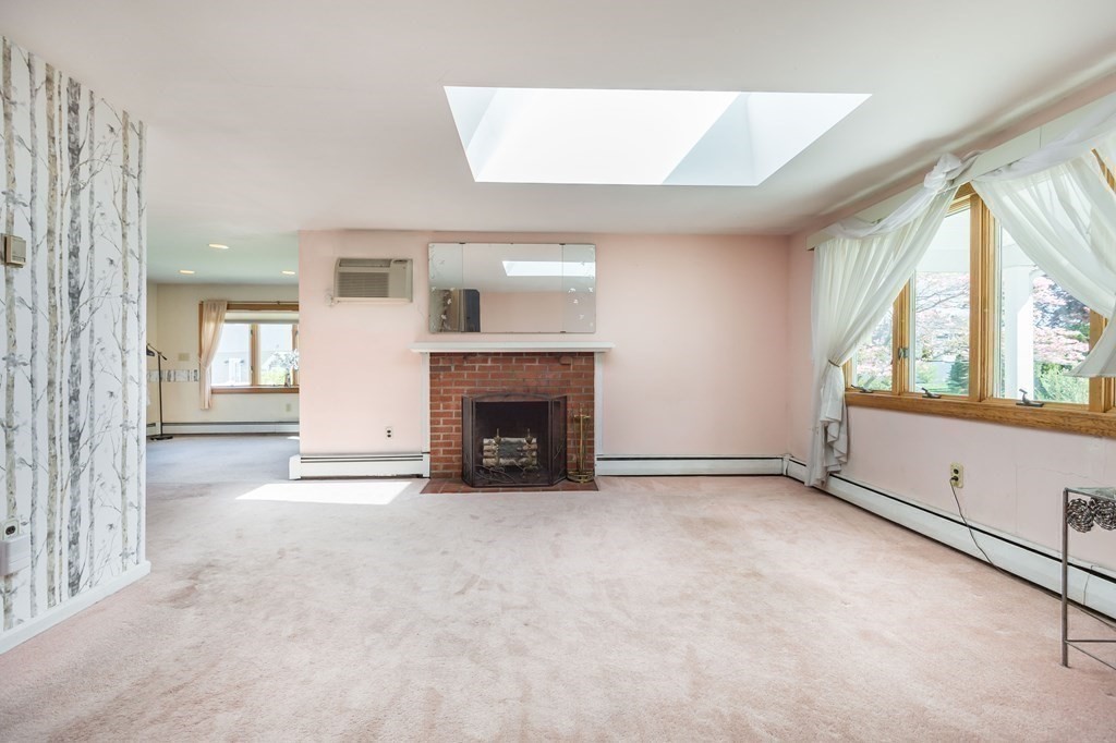 5 Rich Road Woburn, MA 01801 - Photo 9 of 25 a view of an empty room with a fireplace and a window