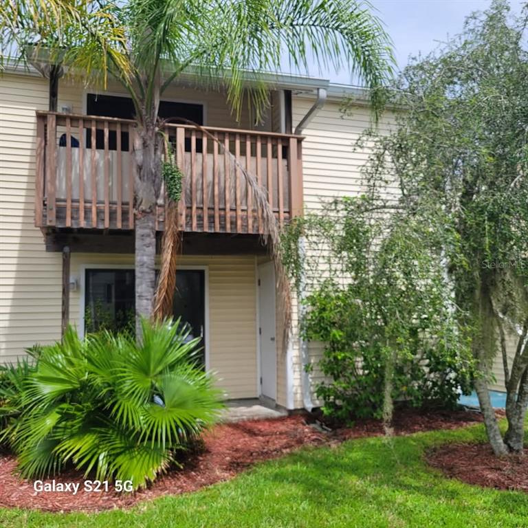 122 Loblolly Court, Unit H Oldsmar, FL 34677 - Photo 1 of 1 a front view of house with yard and green space