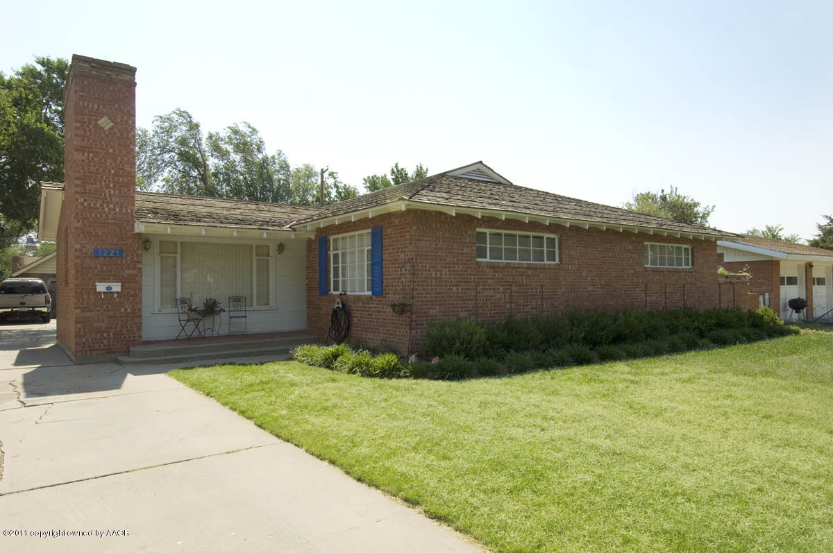 1221 South Austin Street Amarillo, TX 79102 - Photo 1 of 28 a front view of a house with garden