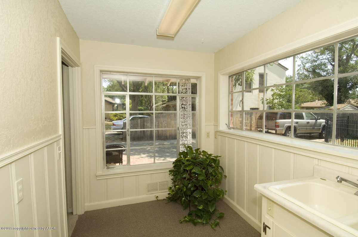 1221 South Austin Street Amarillo, TX 79102 - Photo 6 of 28 a bathroom with a sink and a large window