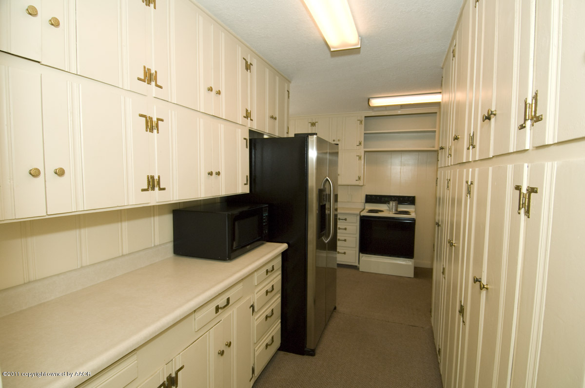 1221 South Austin Street Amarillo, TX 79102 - Photo 7 of 28 a kitchen with a refrigerator and a sink