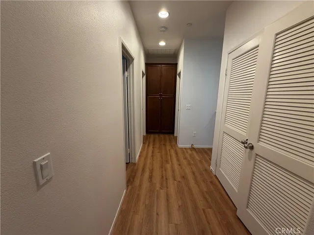 a view of hallway with wooden floor