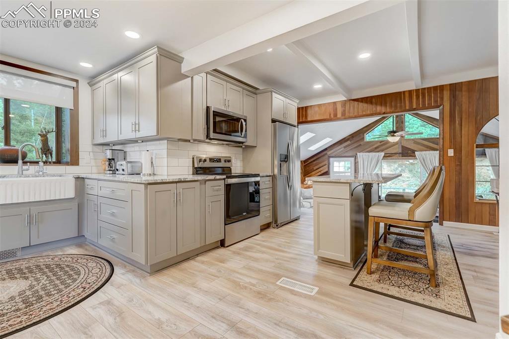 1699 Spring Valley Drive Divide, CO 80814 - Photo 11 of 44 a kitchen with a sink a counter top space stainless steel appliances and cabinets