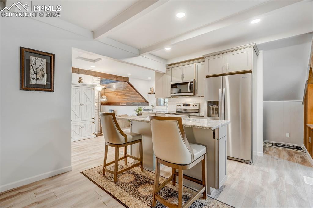 1699 Spring Valley Drive Divide, CO 80814 - Photo 12 of 44 a dining room with stainless steel appliances a dining table and chairs