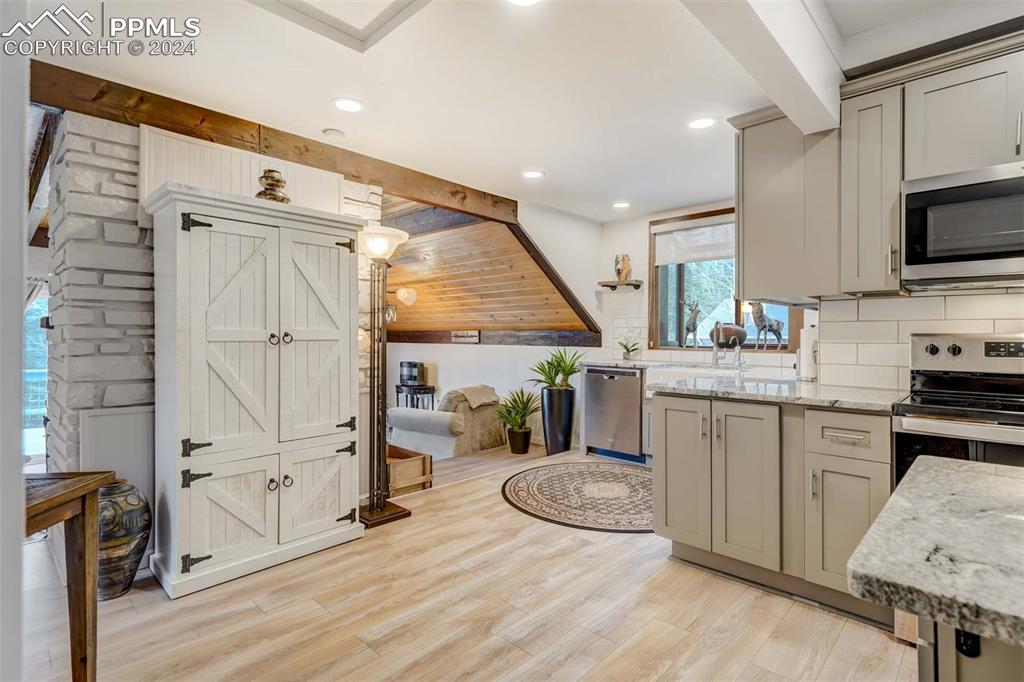 1699 Spring Valley Drive Divide, CO 80814 - Photo 14 of 44 a kitchen with stainless steel appliances granite countertop a stove a sink and a microwave