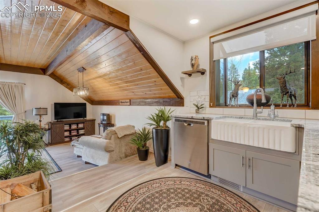 1699 Spring Valley Drive Divide, CO 80814 - Photo 15 of 44 a living room with furniture a flat screen tv and a floor to ceiling window