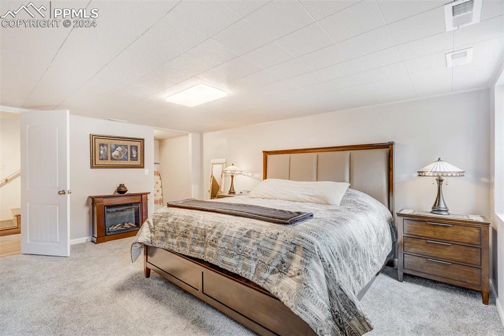 1699 Spring Valley Drive Divide, CO 80814 - Photo 25 of 44 a bedroom with a bed and a lamp on table