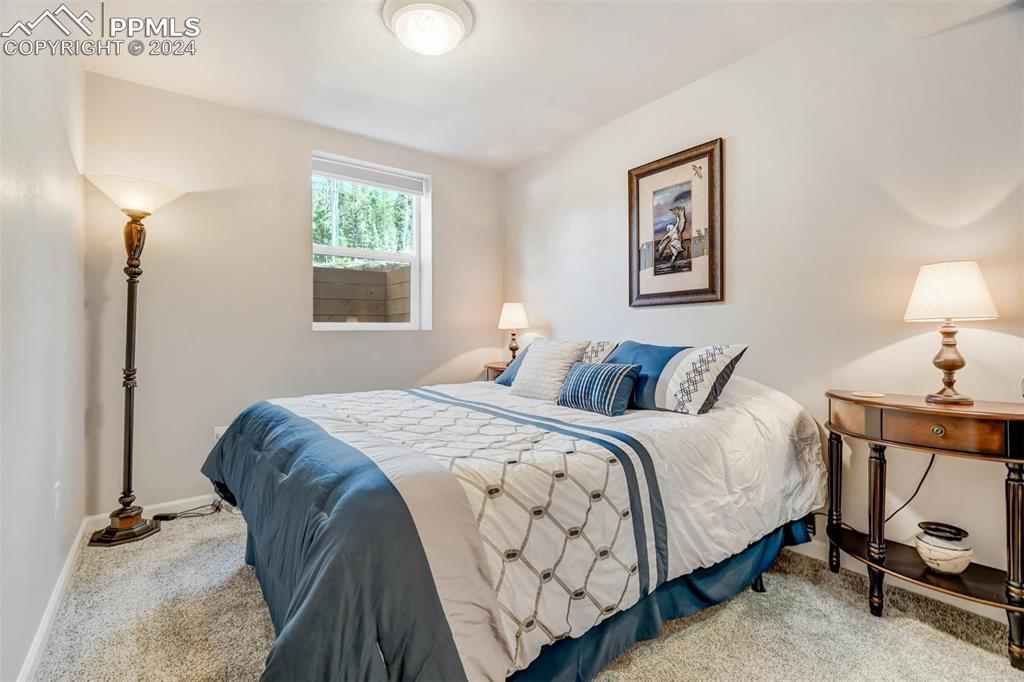 1699 Spring Valley Drive Divide, CO 80814 - Photo 38 of 44 a bedroom with a bed and a lamp