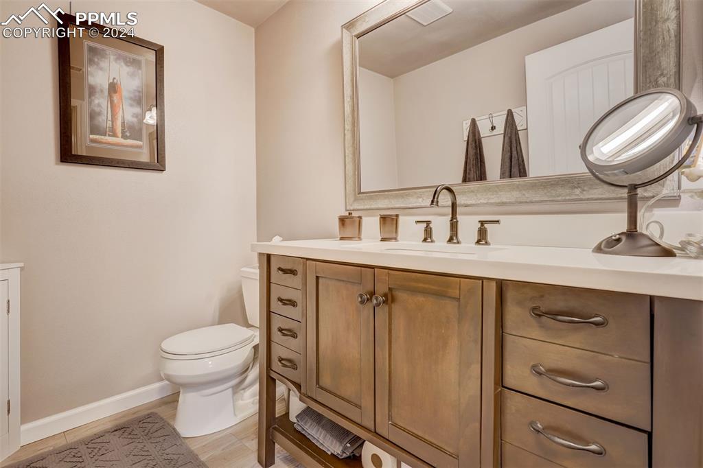 1699 Spring Valley Drive Divide, CO 80814 - Photo 39 of 44 a bathroom with a toilet a sink and mirror