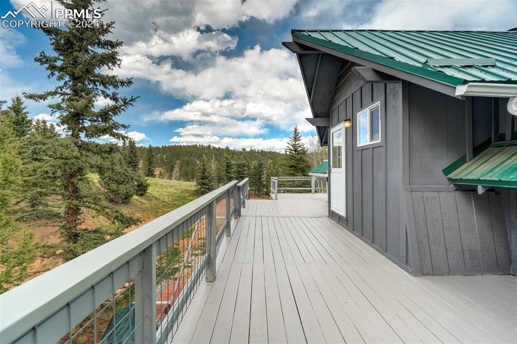 1699 Spring Valley Drive Divide, CO 80814 - Photo 41 of 44 a balcony with wooden floor and outdoor space