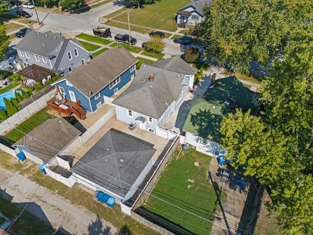 an aerial view of a house with a swimming pool