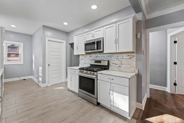 a kitchen with stainless steel appliances granite countertop a stove and a refrigerator