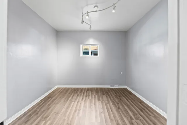 a view of room with wooden floor and fan