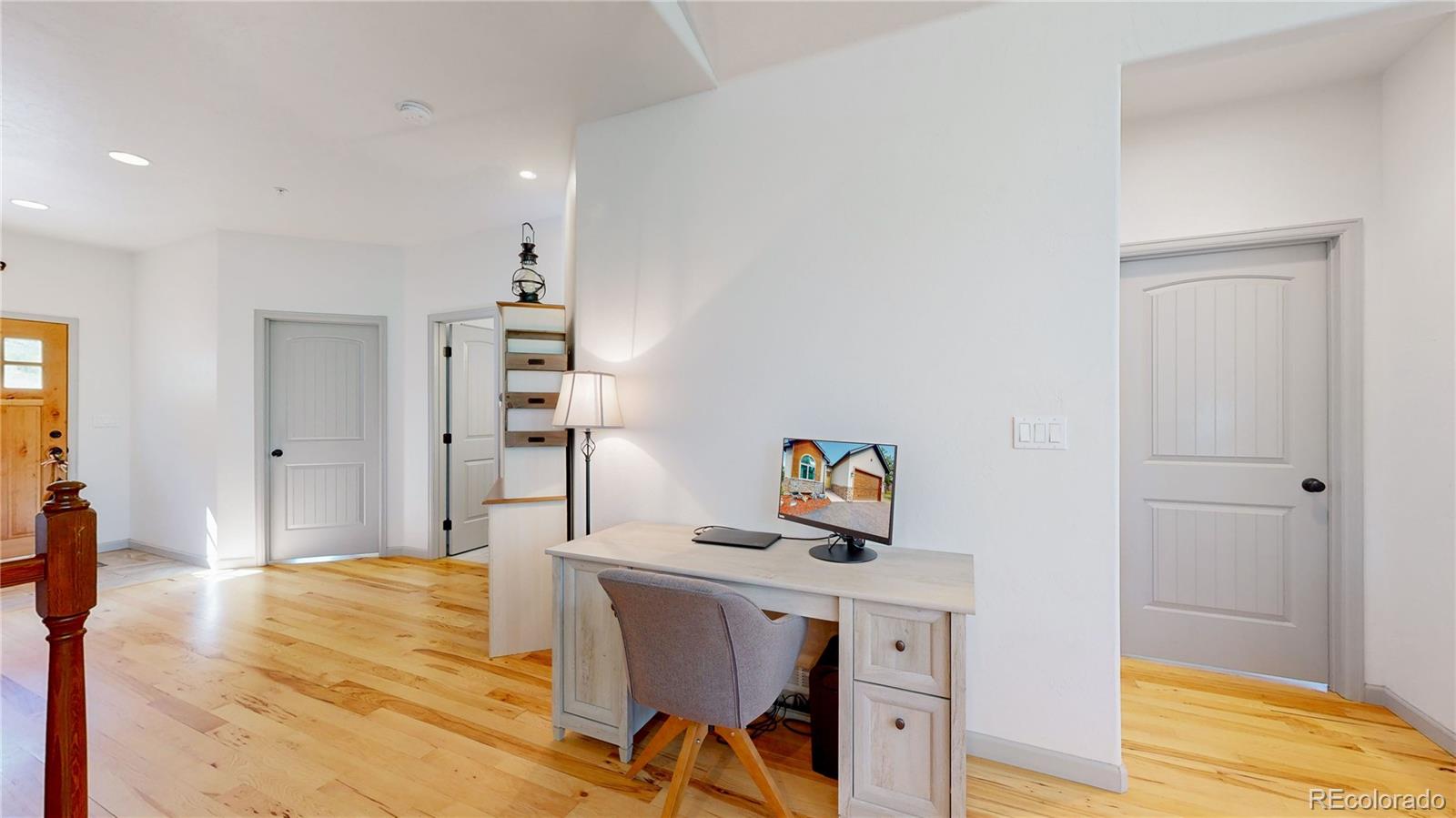 230 Mohawk Trail Pine, CO 80470 - Photo 11 of 39 a workspace with furniture and wooden floor