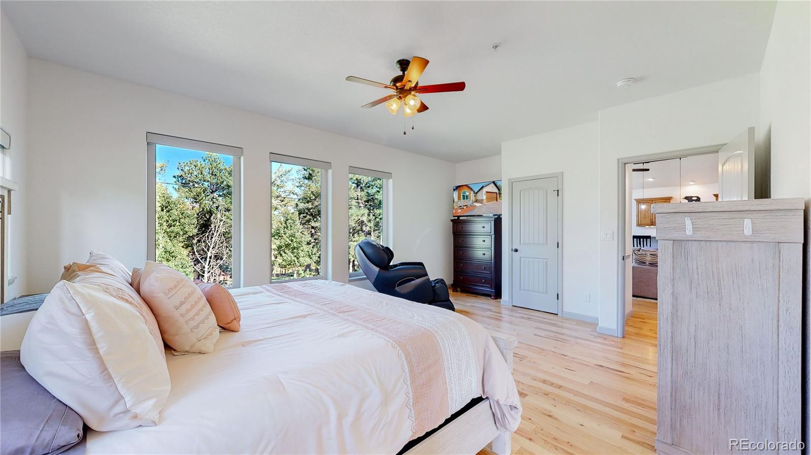 230 Mohawk Trail Pine, CO 80470 - Photo 13 of 39 a bedroom with a bed and a chandelier