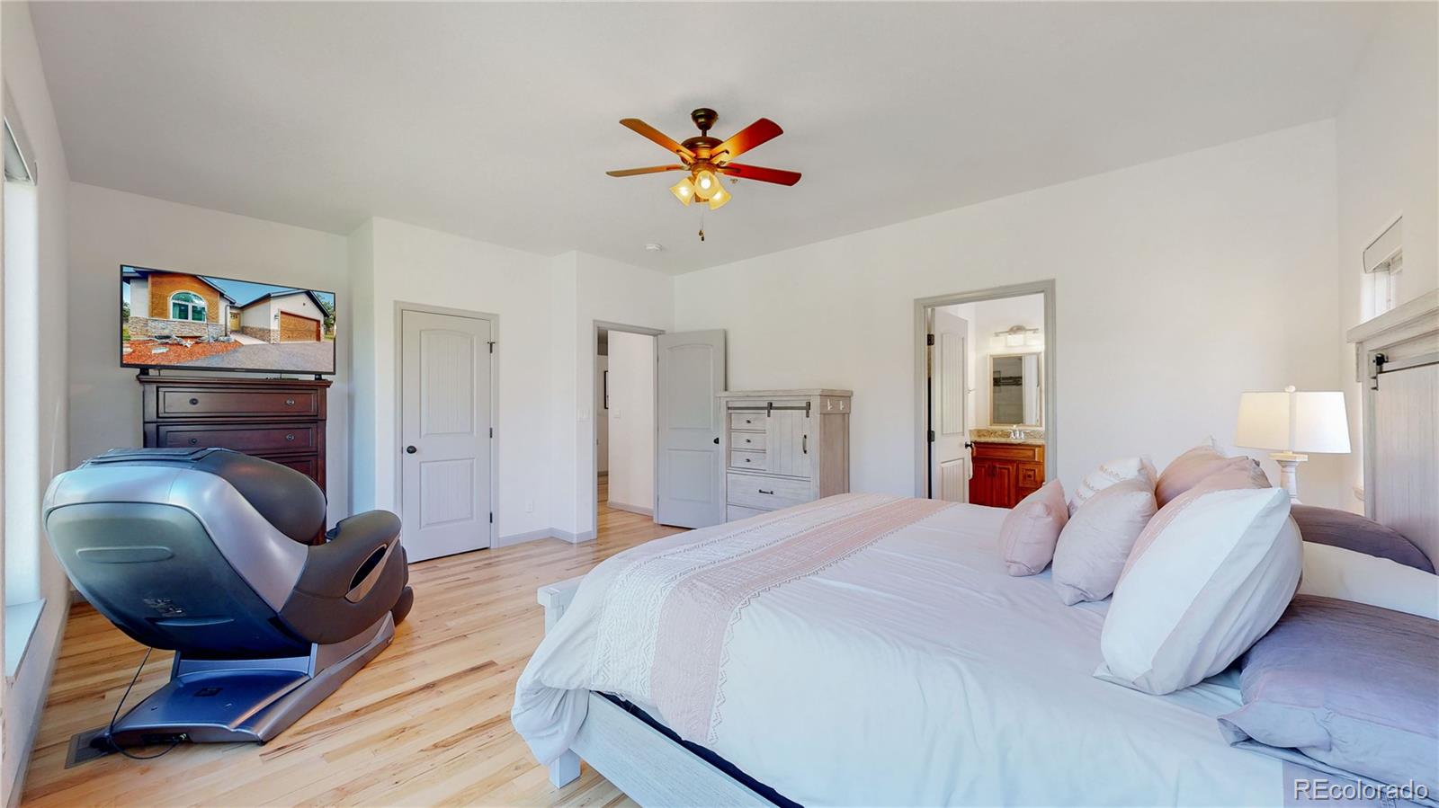 230 Mohawk Trail Pine, CO 80470 - Photo 14 of 39 a bedroom with furniture and a chandelier