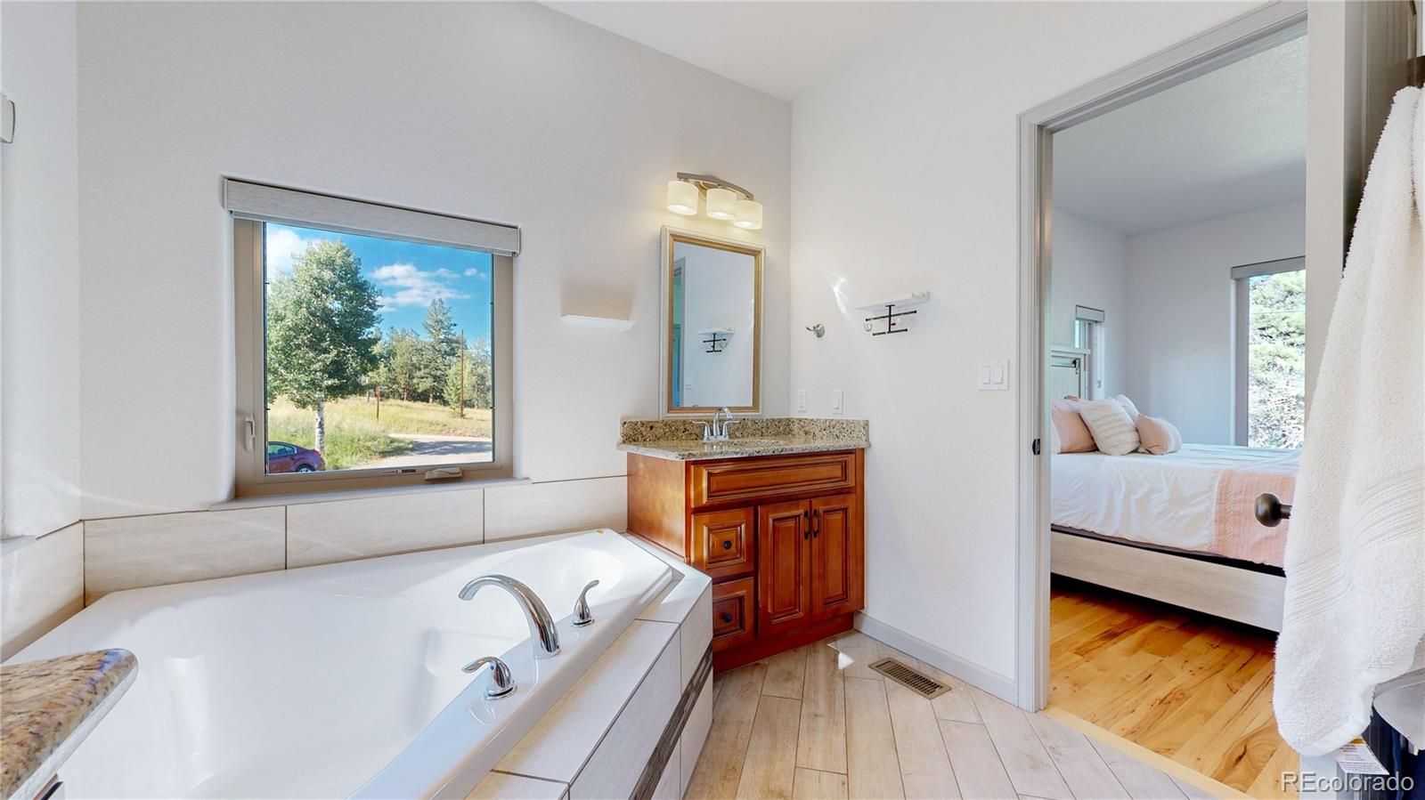 230 Mohawk Trail Pine, CO 80470 - Photo 16 of 39 a bathroom with a tub sink and mirror