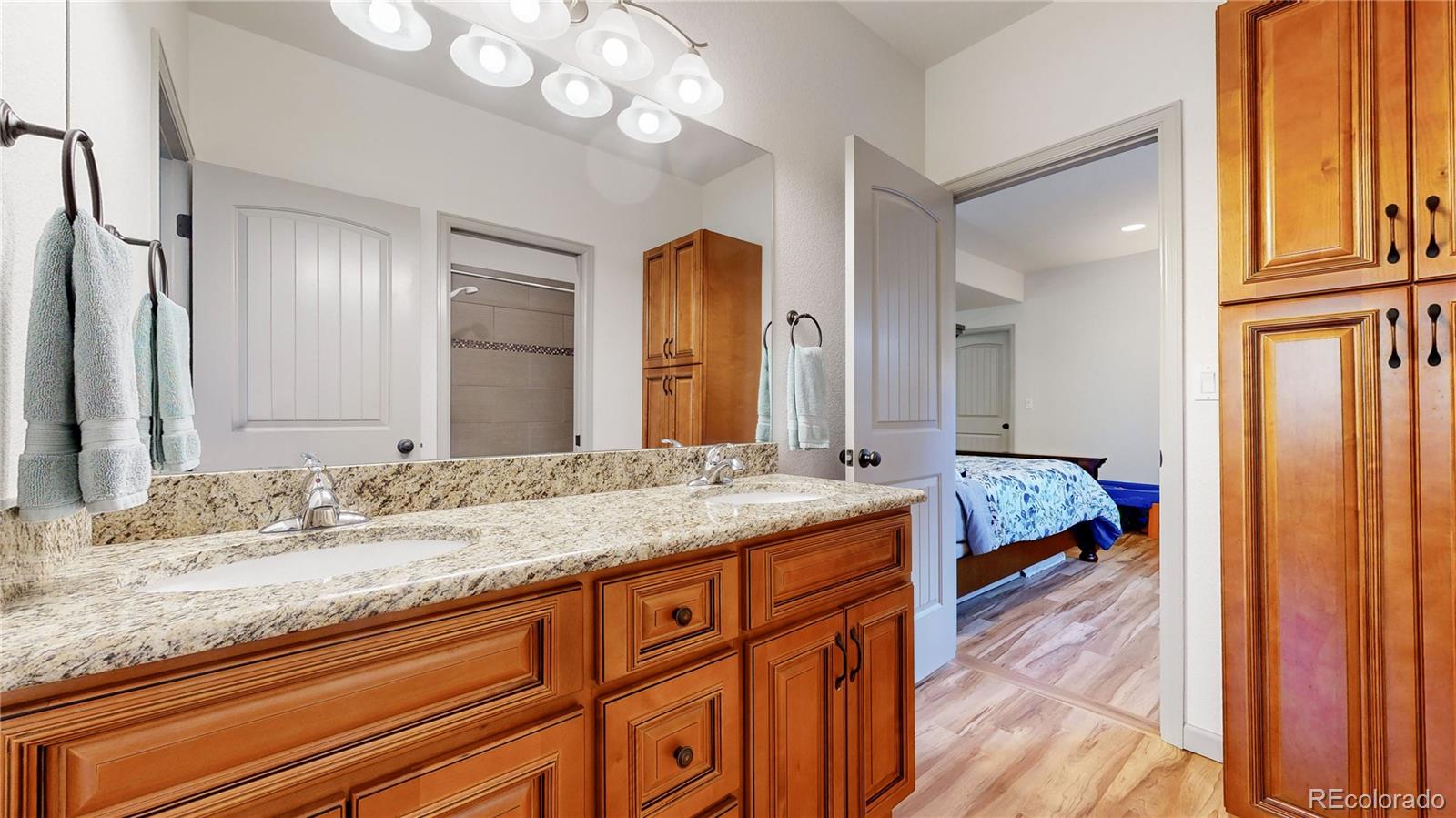 230 Mohawk Trail Pine, CO 80470 - Photo 20 of 39 a en suite bathroom with a granite countertop sink and a mirror