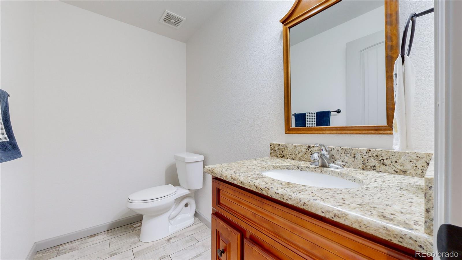 230 Mohawk Trail Pine, CO 80470 - Photo 23 of 39 a bathroom with a granite countertop sink and a mirror
