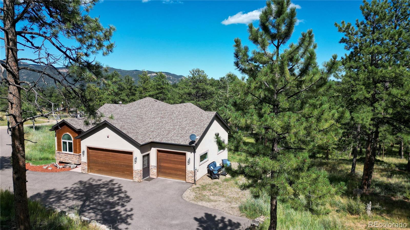 230 Mohawk Trail Pine, CO 80470 - Photo 24 of 39 a house with trees in front of it