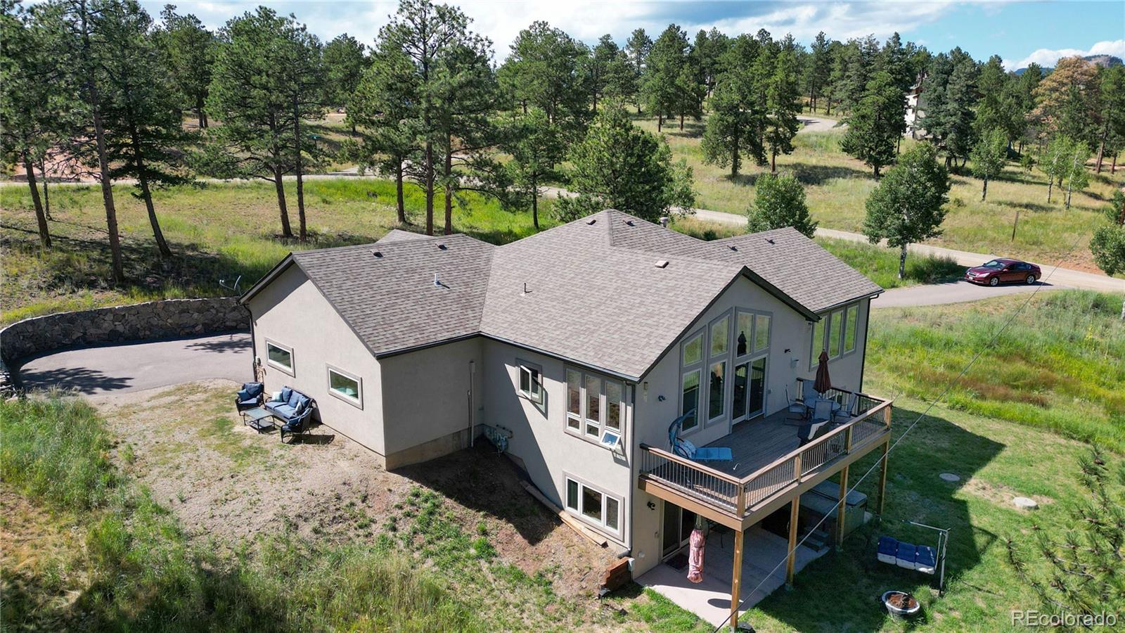 230 Mohawk Trail Pine, CO 80470 - Photo 34 of 39 an aerial view of a house with a big yard and large trees