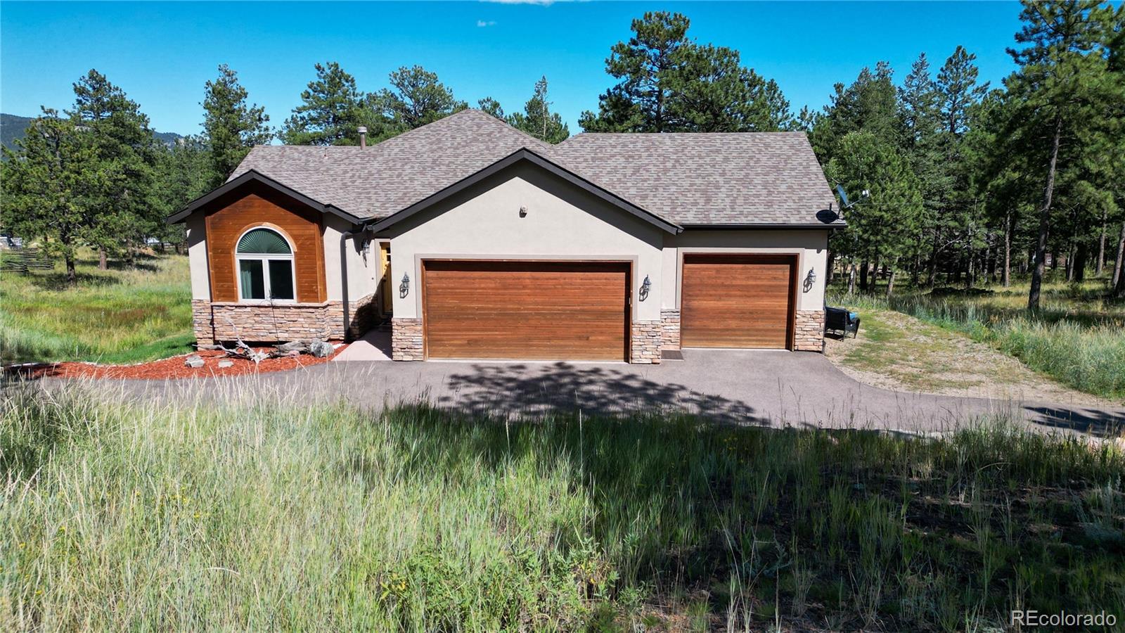 230 Mohawk Trail Pine, CO 80470 - Photo 38 of 39 a front view of a house with a yard and potted plants
