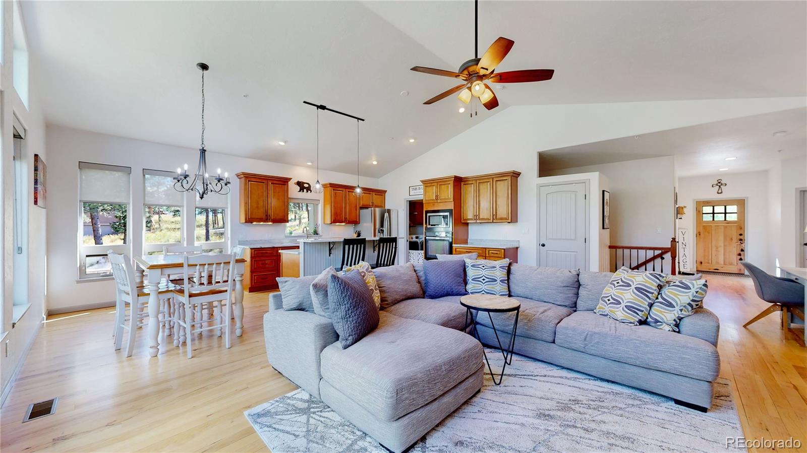 230 Mohawk Trail Pine, CO 80470 - Photo 4 of 39 a living room with furniture kitchen view and a chandelier