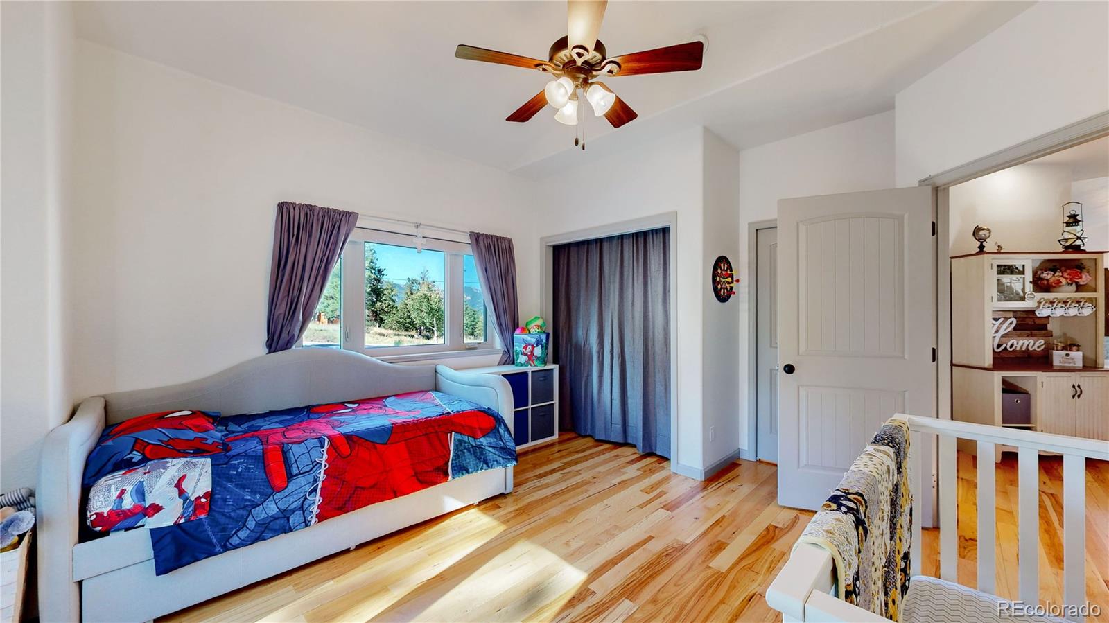 230 Mohawk Trail Pine, CO 80470 - Photo 9 of 39 a bedroom with a bed and a book shelf