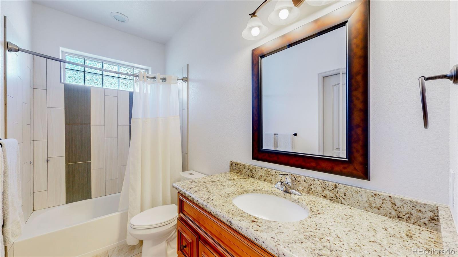 230 Mohawk Trail Pine, CO 80470 - Photo 10 of 39 a bathroom with a granite countertop sink toilet and shower