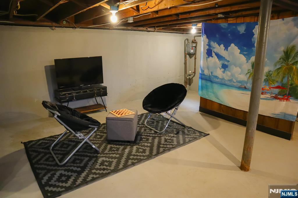 78 Poplar Avenue Little Ferry, NJ 07643 - Photo 17 of 23 a living room with chairs and a flat screen tv
