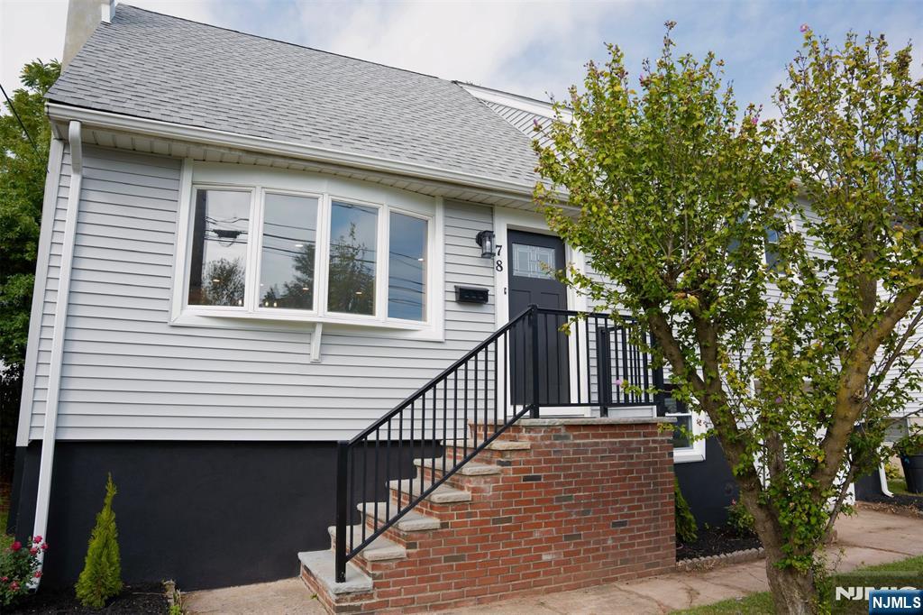 78 Poplar Avenue Little Ferry, NJ 07643 - Photo 18 of 23 a front view of a house with a tree