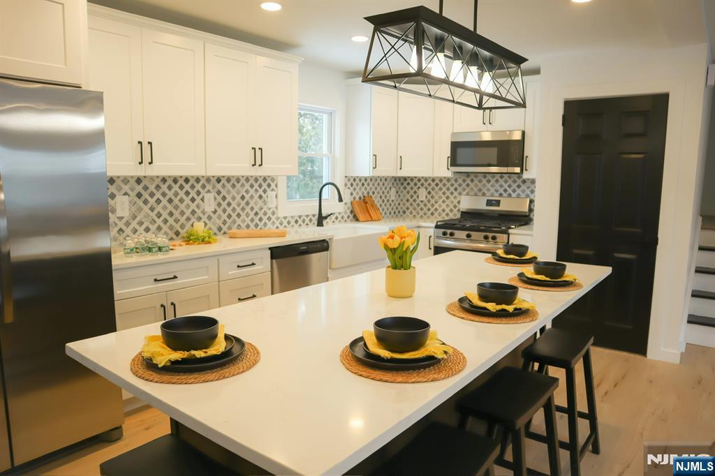 78 Poplar Avenue Little Ferry, NJ 07643 - Photo 2 of 23 a kitchen with a table chairs and a stove top oven