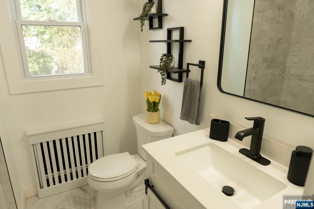 78 Poplar Avenue Little Ferry, NJ 07643 - Photo 6 of 23 a bathroom with a sink and a toilet