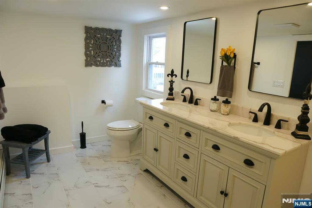 78 Poplar Avenue Little Ferry, NJ 07643 - Photo 9 of 23 a bathroom with a granite countertop toilet sink and mirror