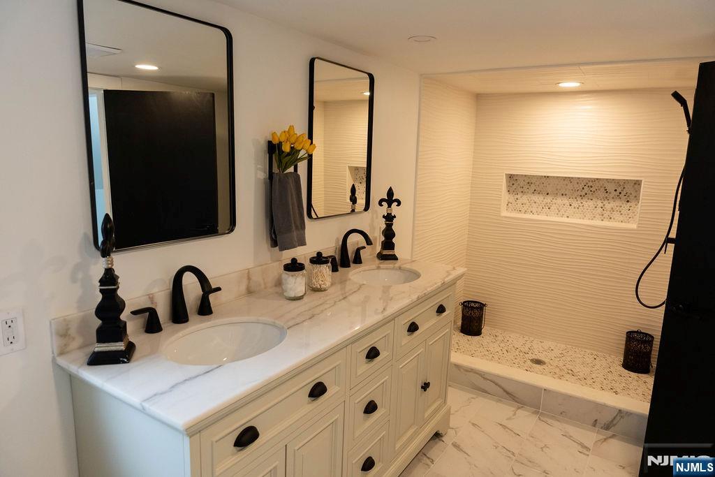 78 Poplar Avenue Little Ferry, NJ 07643 - Photo 10 of 23 a bathroom with a sink and a mirror