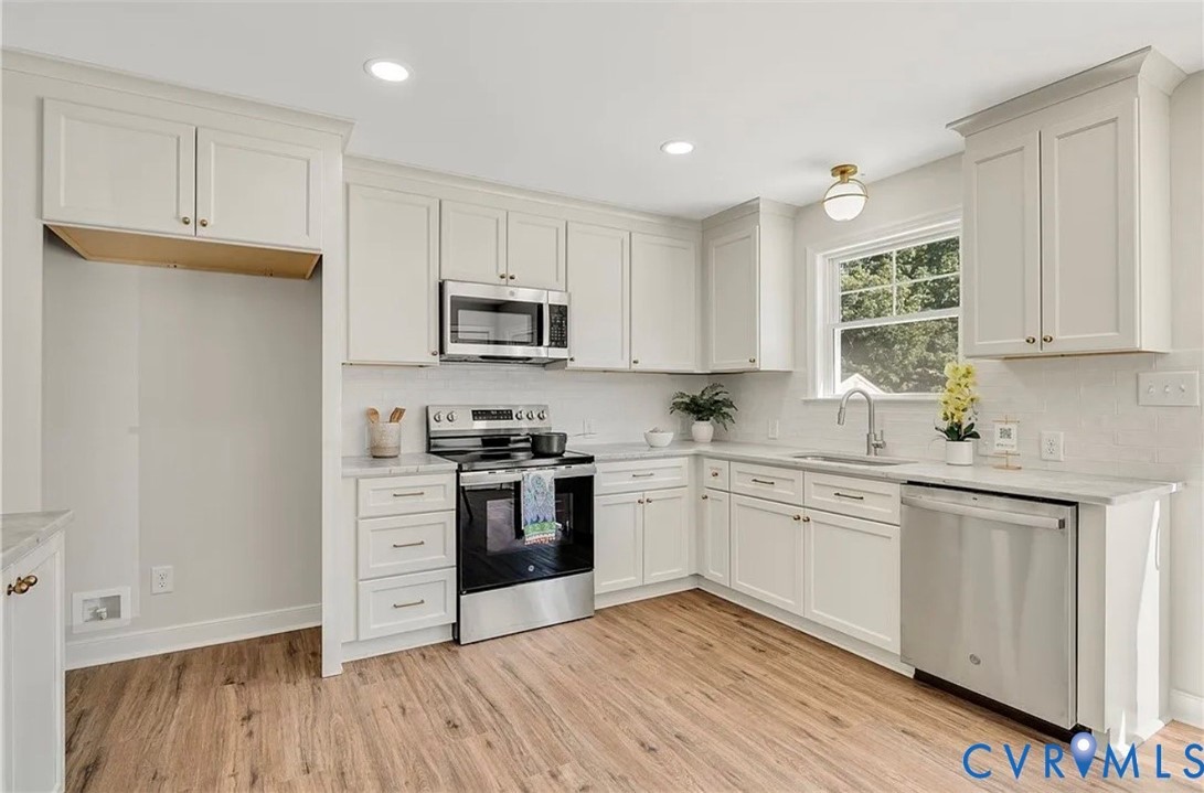14915 Lebanon Road Spring Grove, VA 23881 - Photo 2 of 6 a kitchen with granite countertop white cabinets and stainless steel appliances