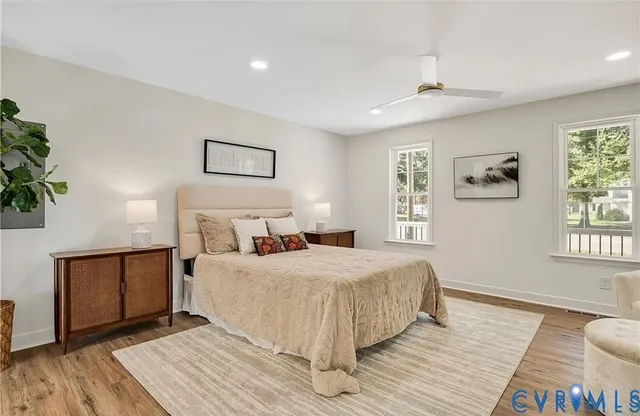 a bedroom with a bed and a wooden floor