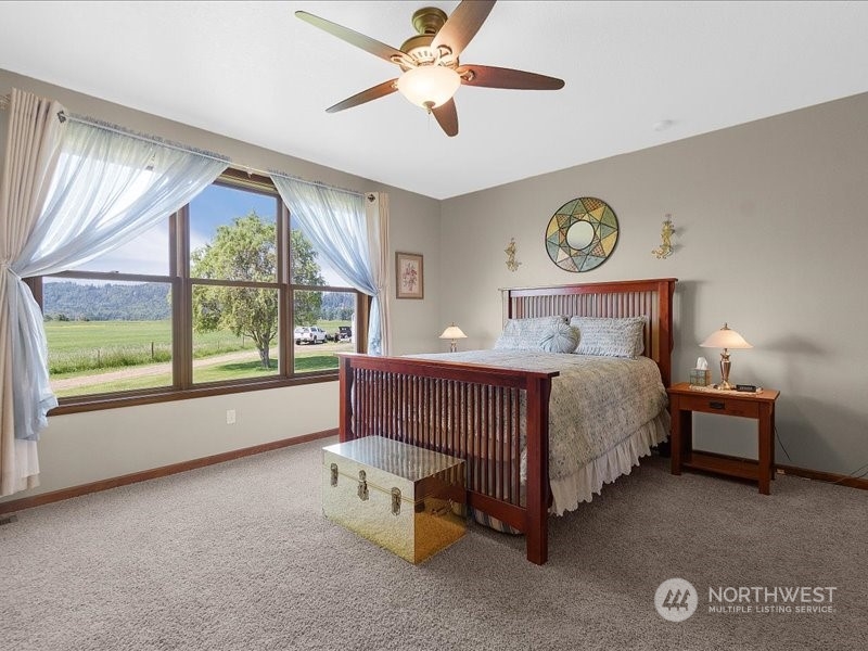 285 West Birnie Slough Road Cathlamet, WA 98612 - Photo 16 of 40 a bedroom with a bed and a window